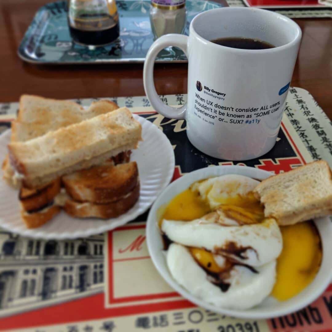 Poached eggs, soy sauce and white pepper with slices of toast slathered in kaya jam for dipping; on the mug is Billy Gregory’s 2015 #SUX tweet.